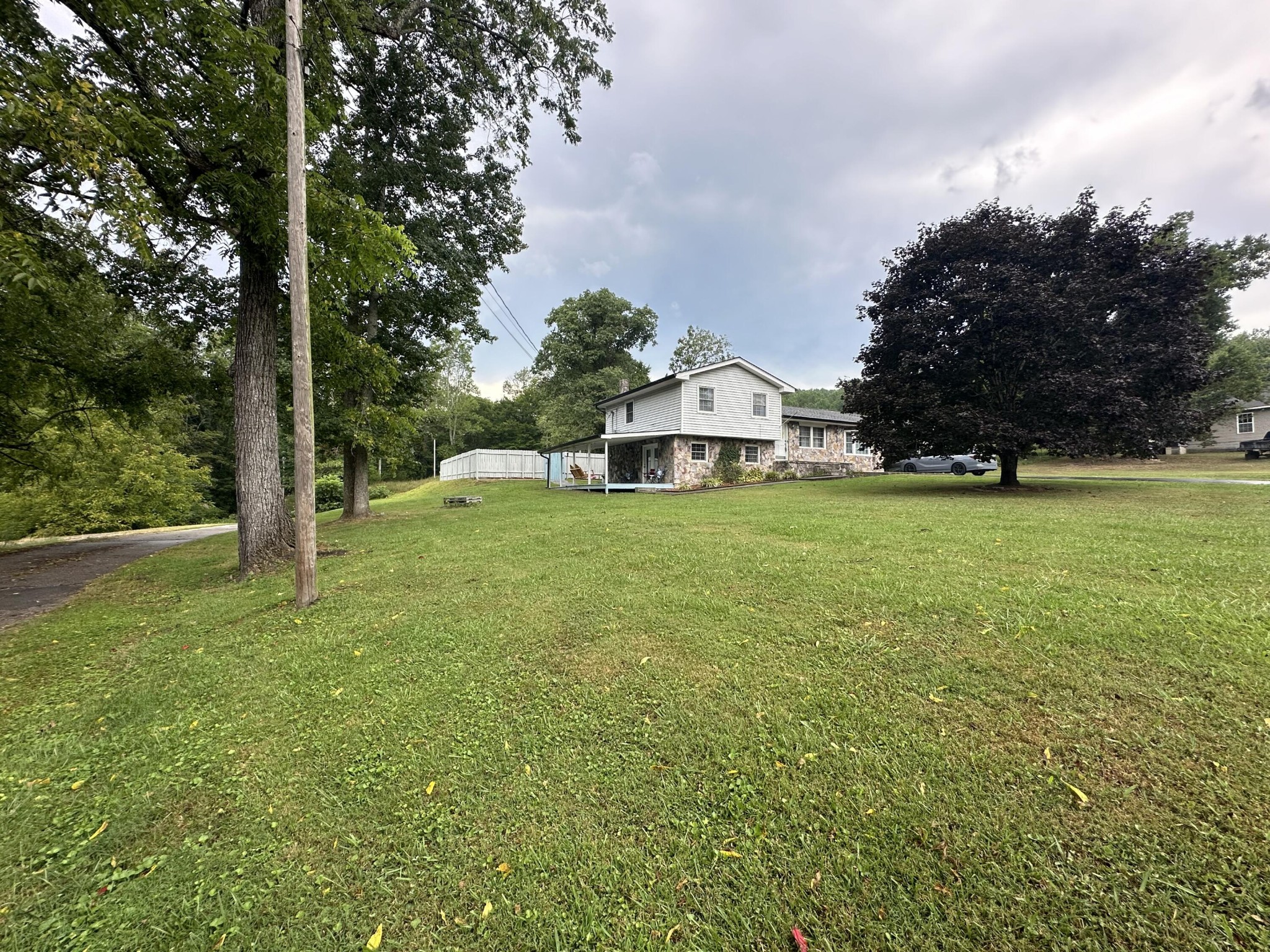 a view of a house with yard and sitting area