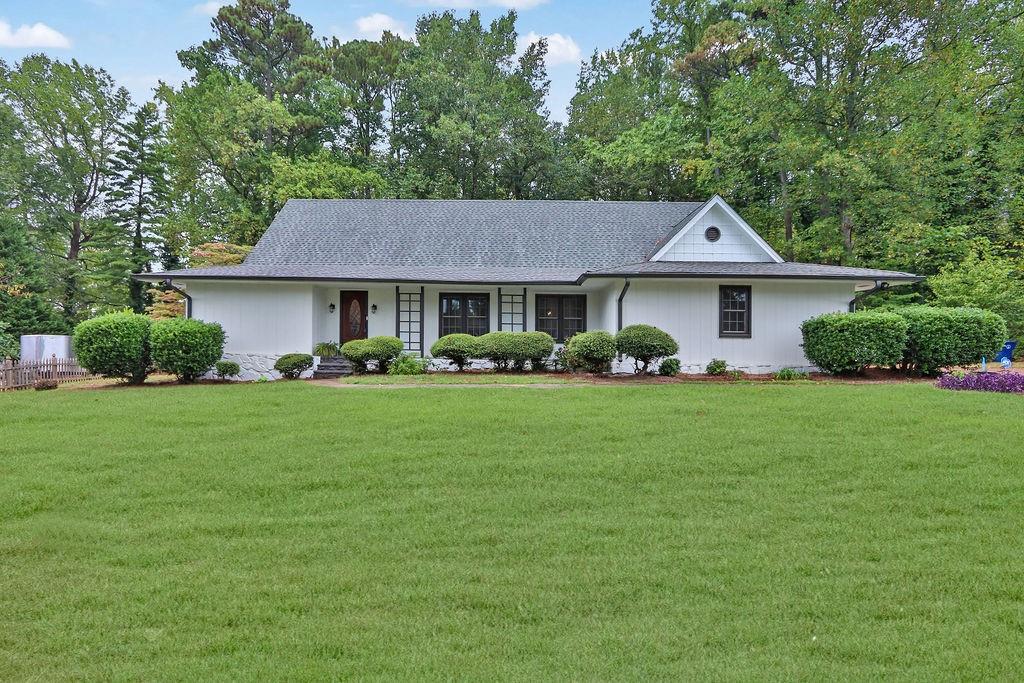 a front view of house with yard and green space