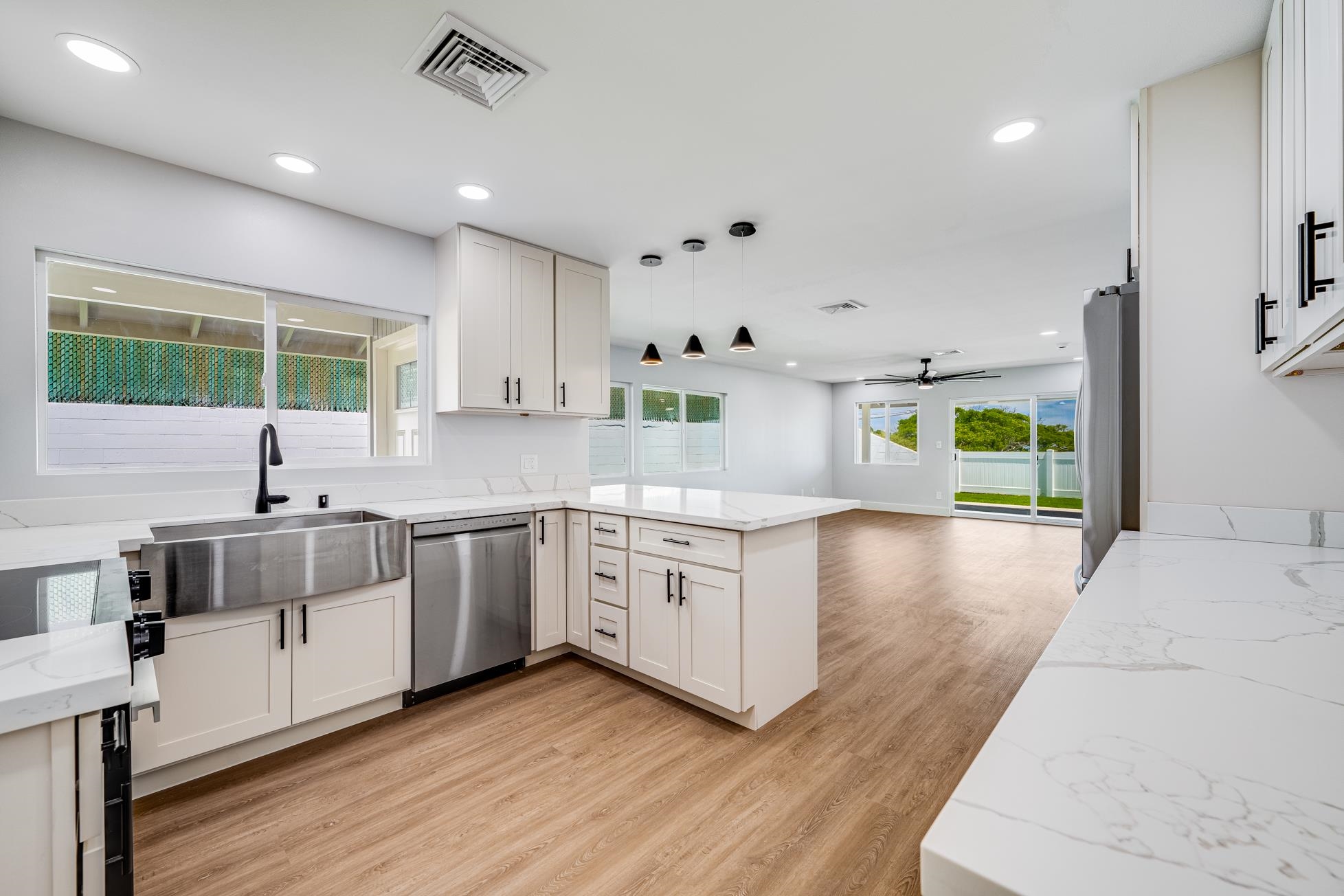 a kitchen with stove cabinets and wooden floor