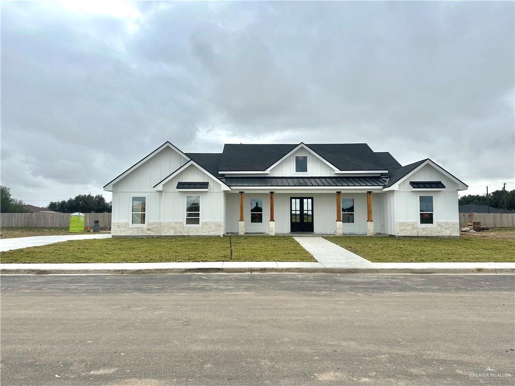 Modern farmhouse with a porch and a front yard