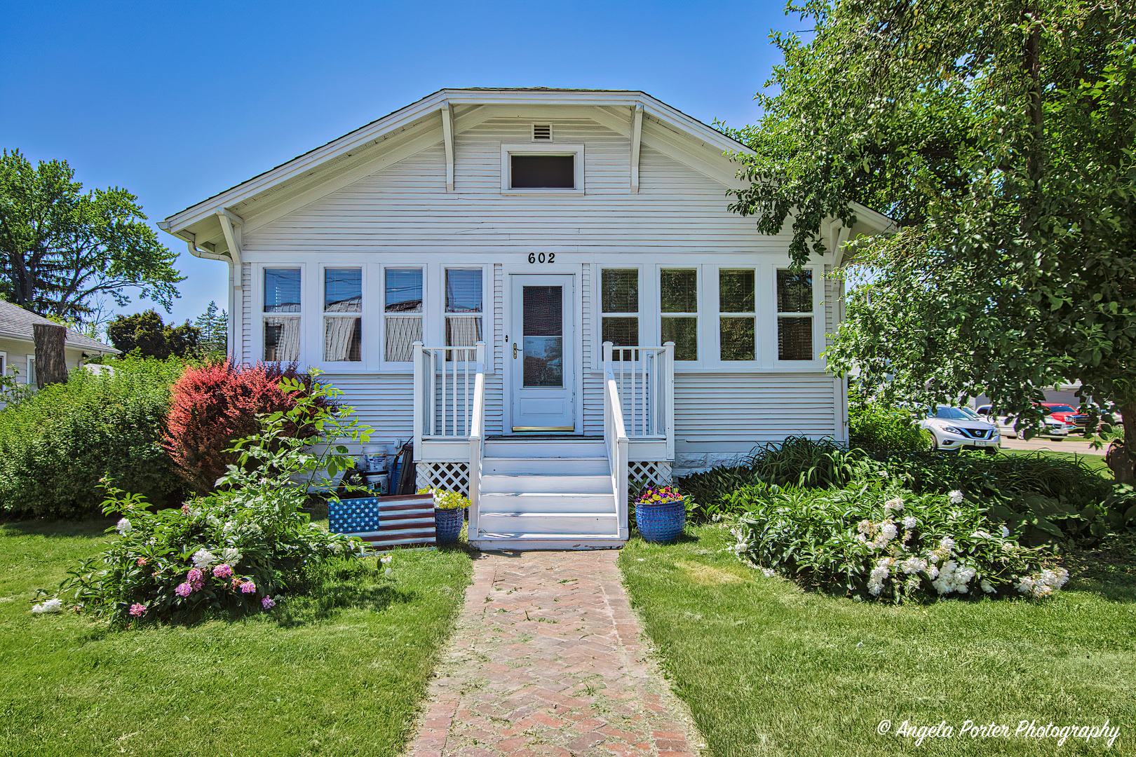 a front view of a house with a garden