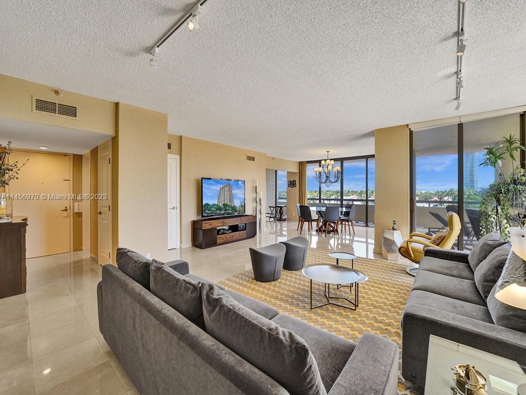 a living room with fireplace furniture and a flat screen tv