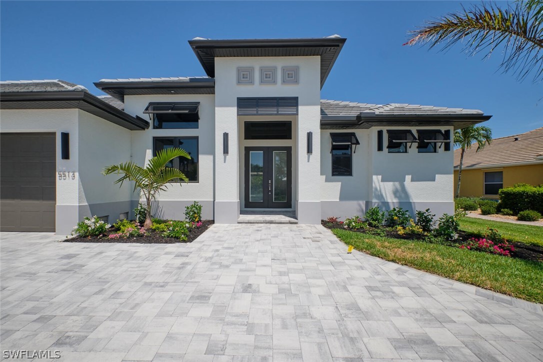 a front view of a house with a garden