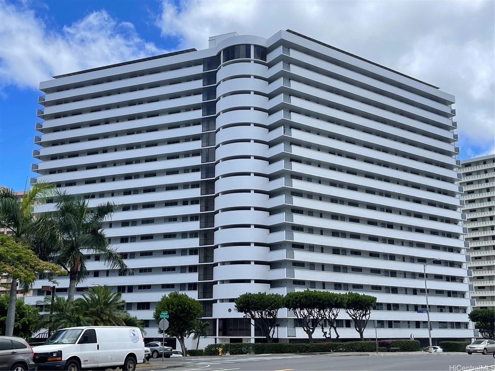 a front view of a building with parking