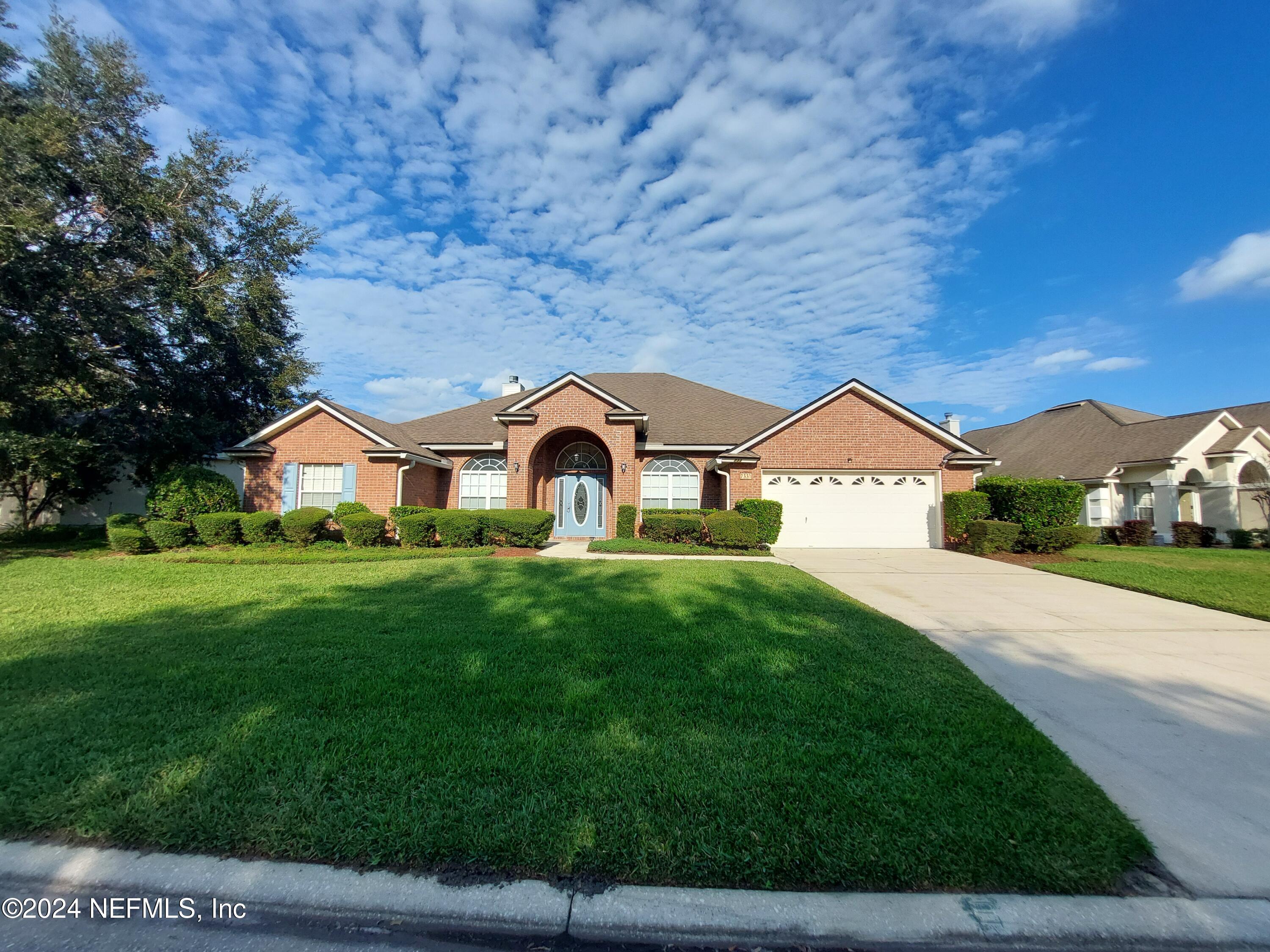 a front view of a house with garden