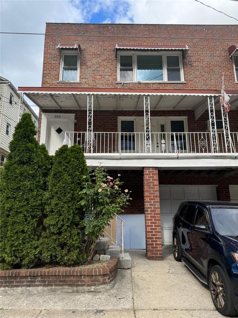 Multi unit property featuring a garage and a balcony