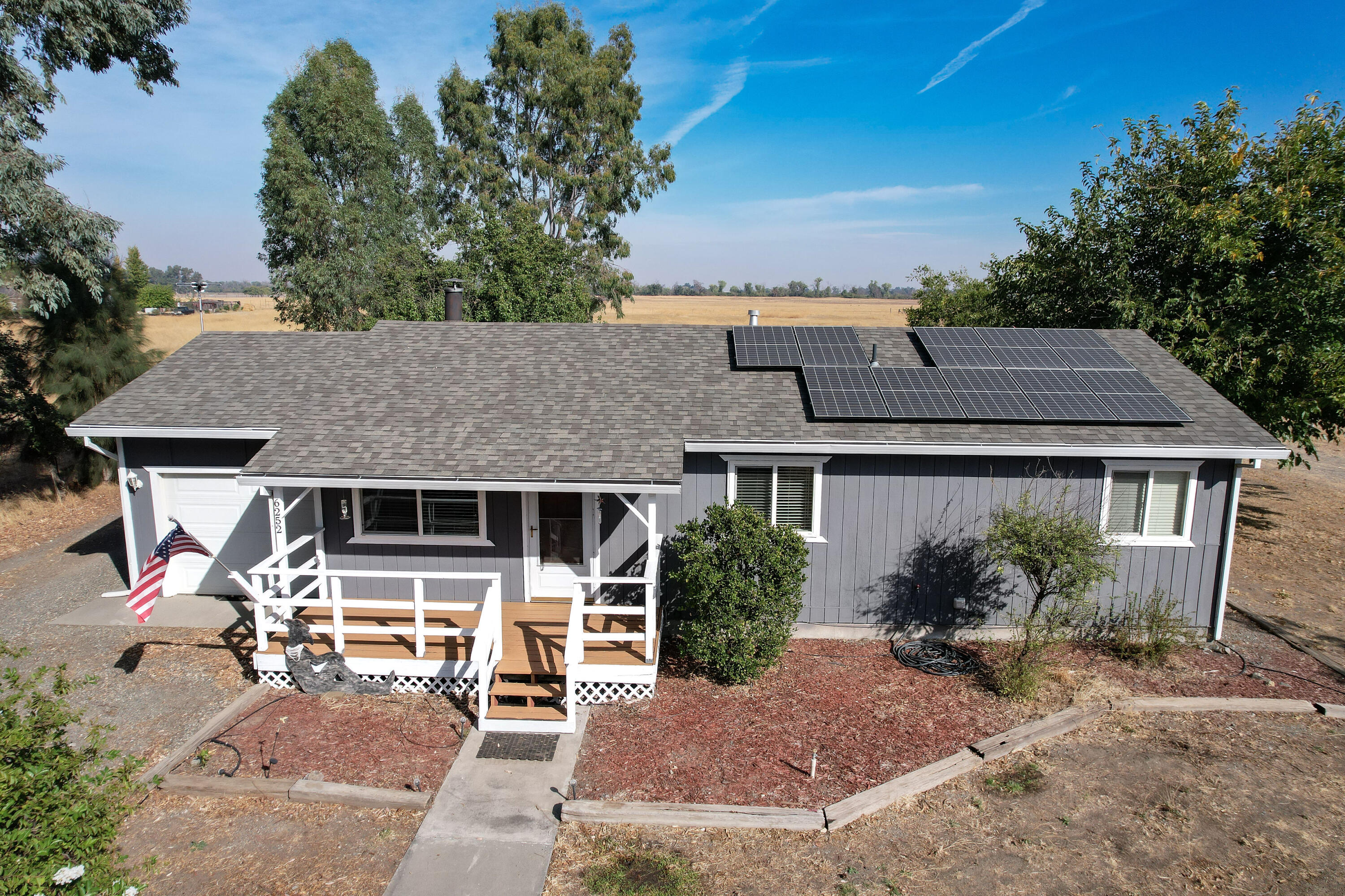 an aerial view of a house with garden space and street view