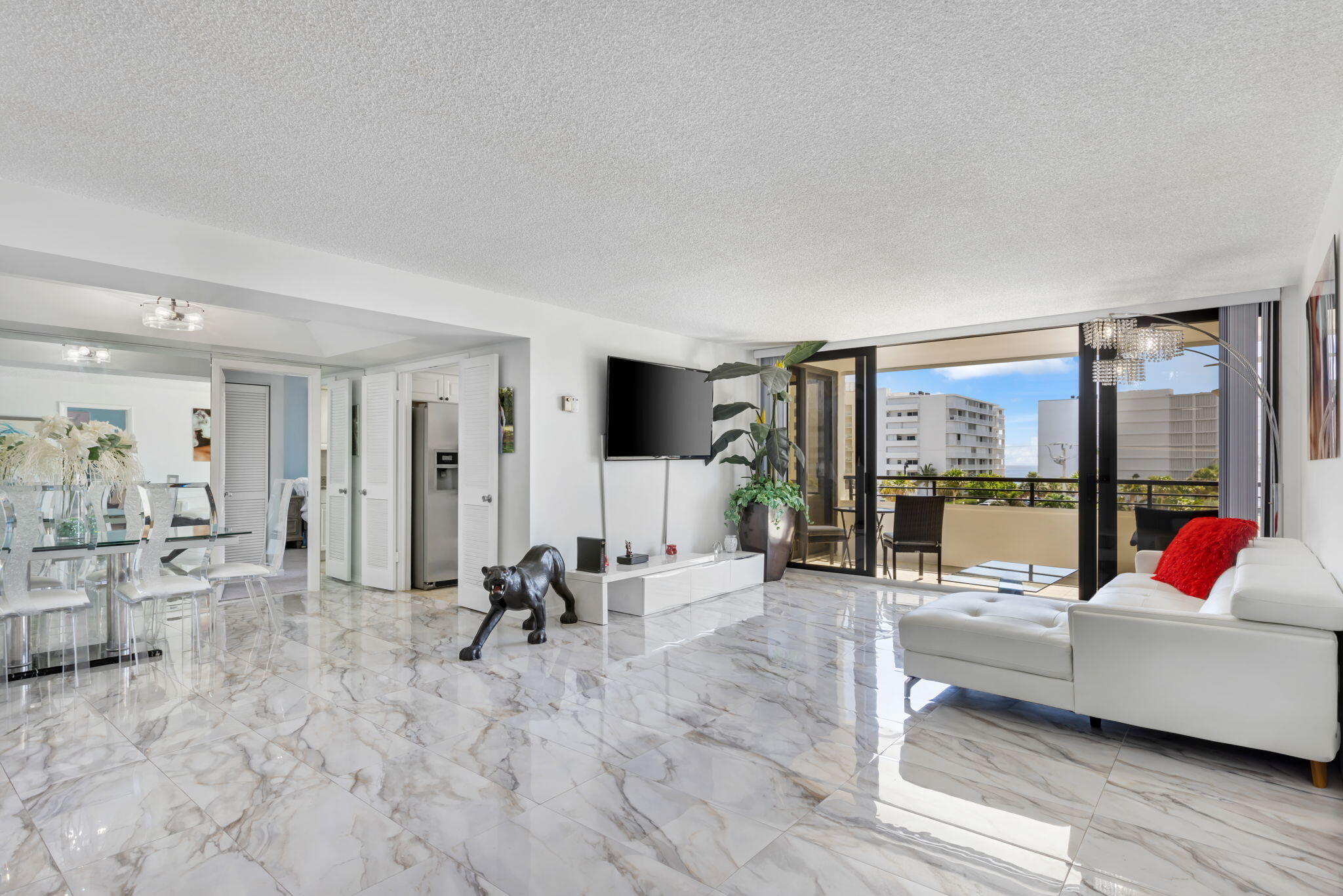 a living room with furniture and large windows