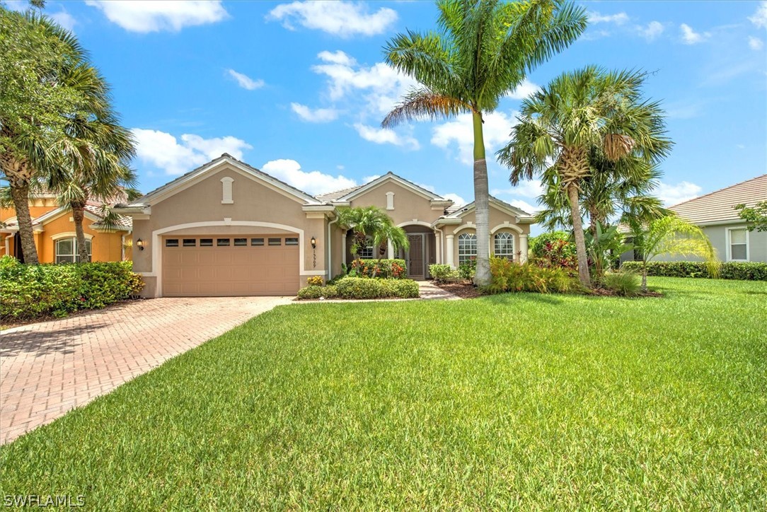 a front view of a house with a yard and garage