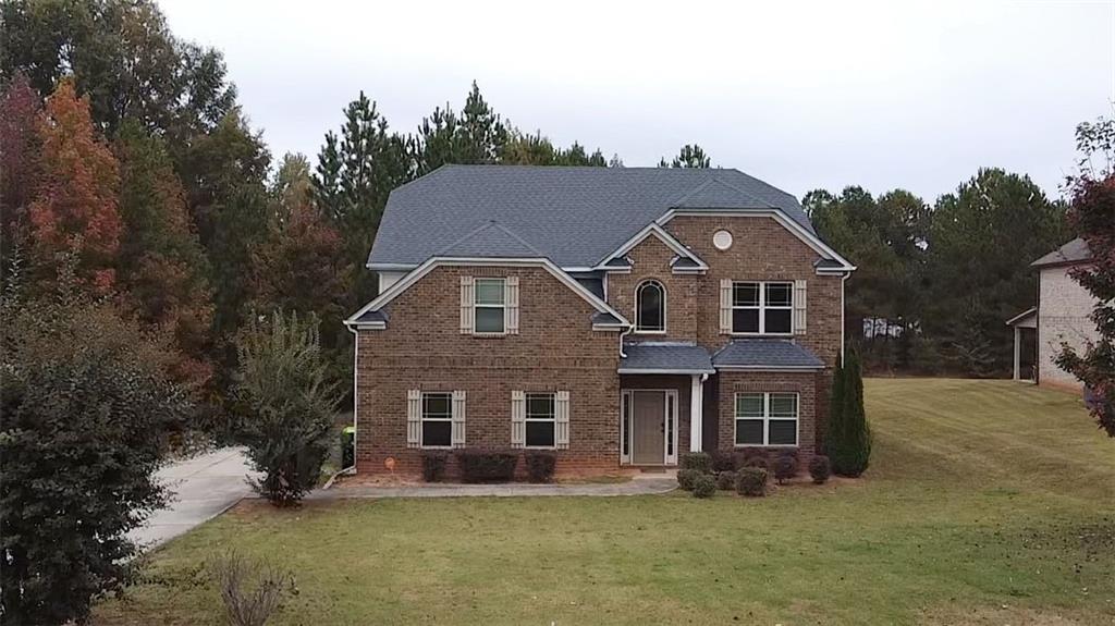 a front view of a house with a yard