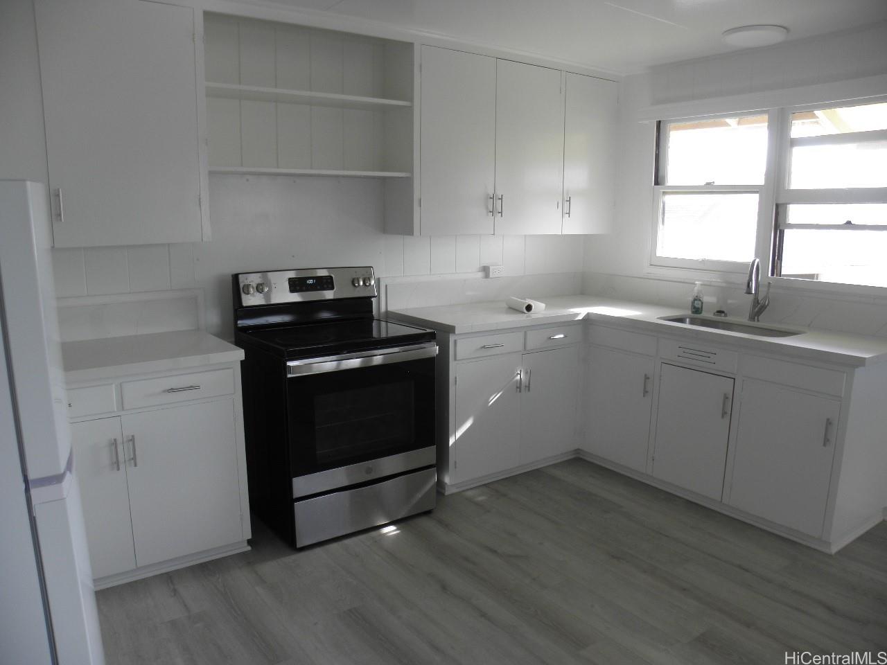 a kitchen with a stove cabinets and a sink