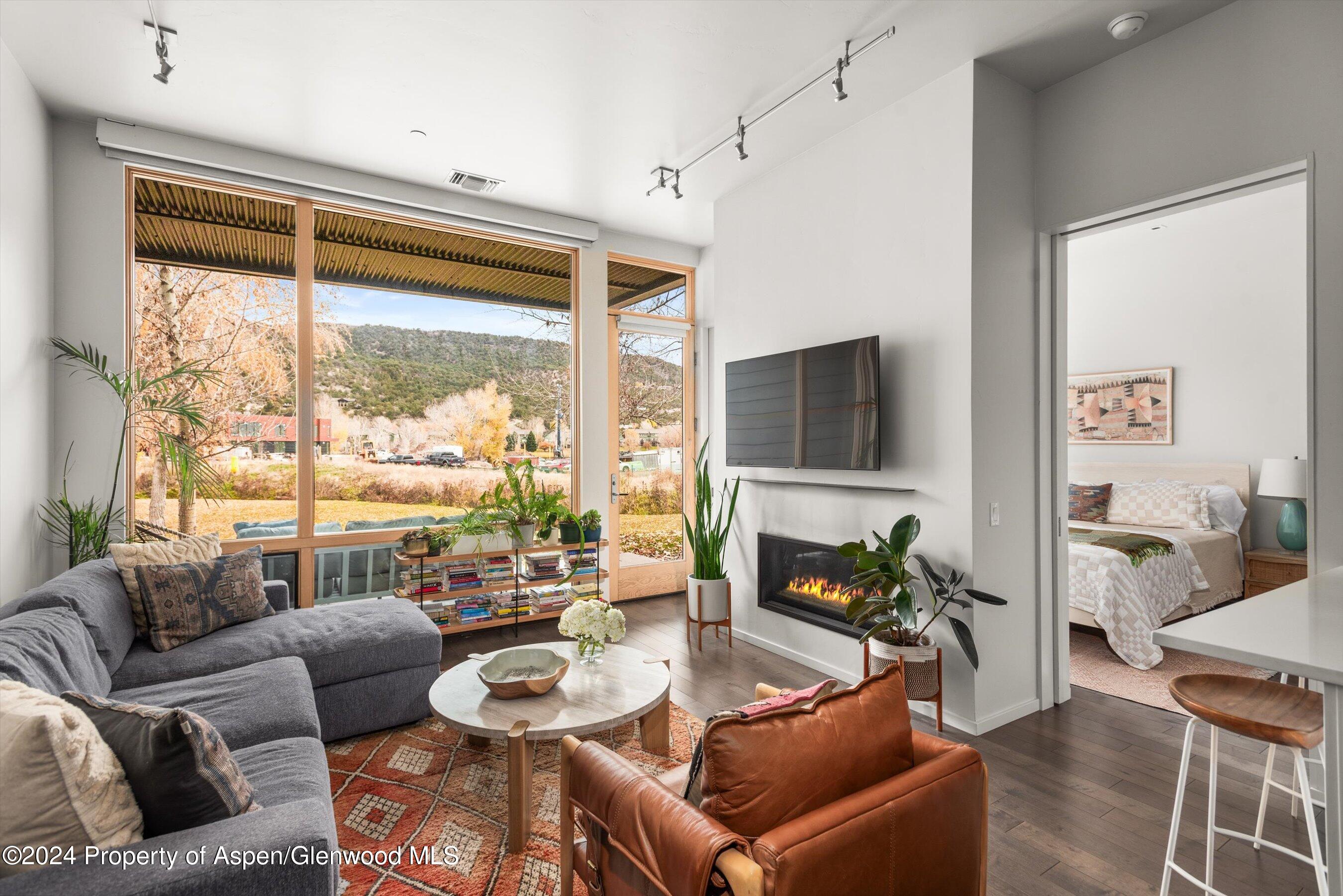 a living room with furniture and a flat screen tv