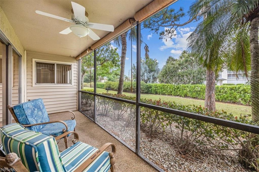 a view of a porch with furniture and a yard