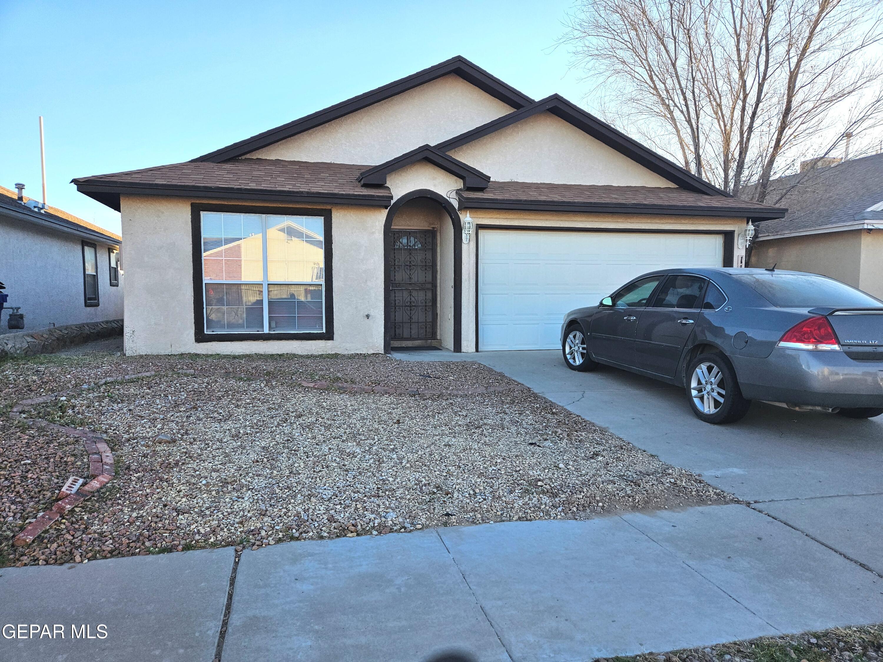 a front view of a house with parking space