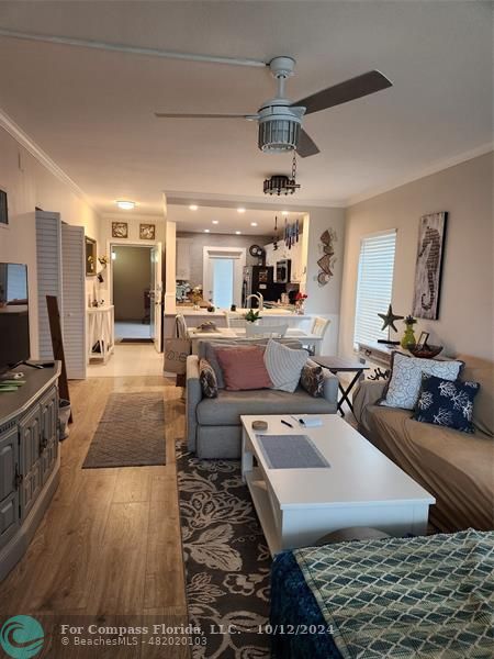 a living room with lots of furniture and kitchen view