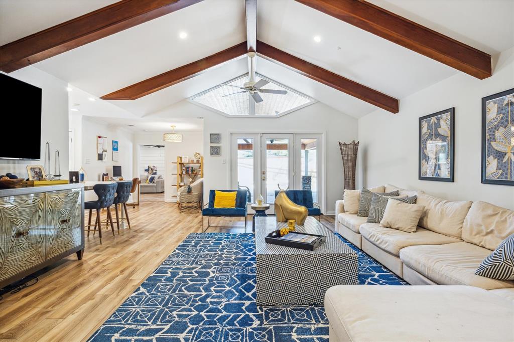 Spacious living room with fireplace, high beamed ceiling