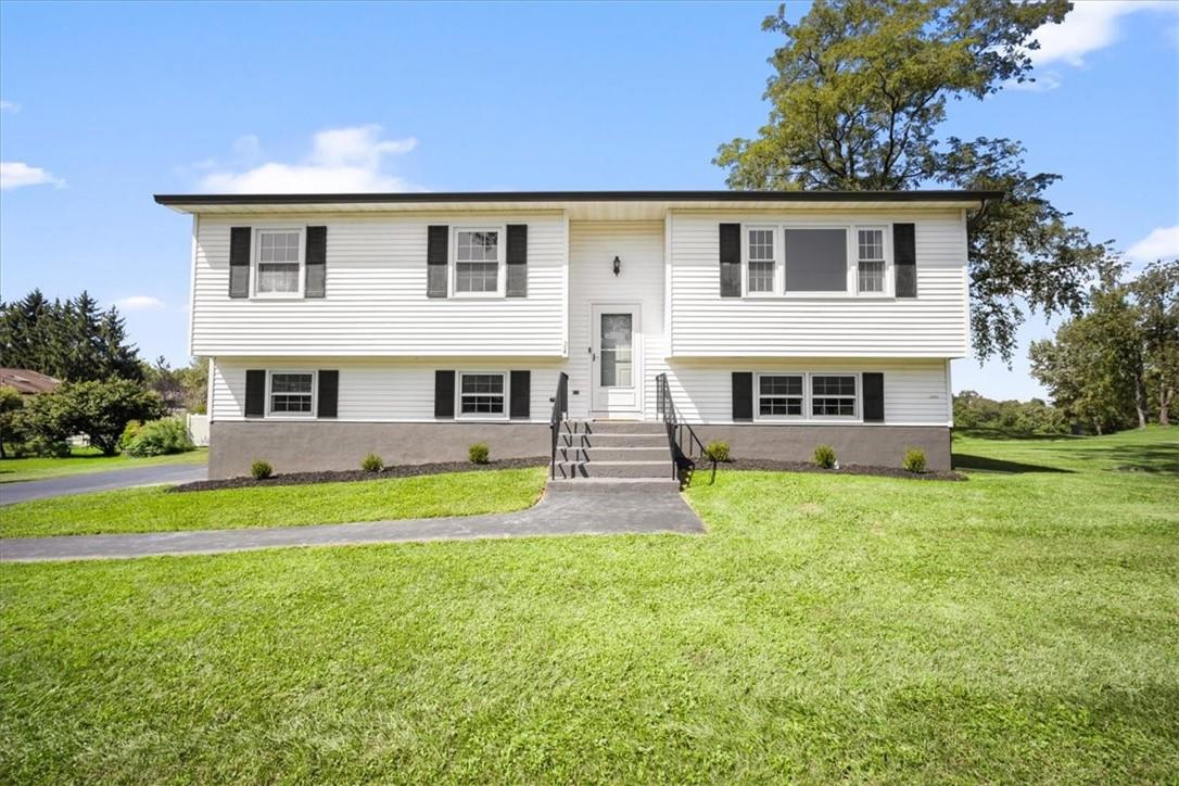 Split foyer home with a front yard