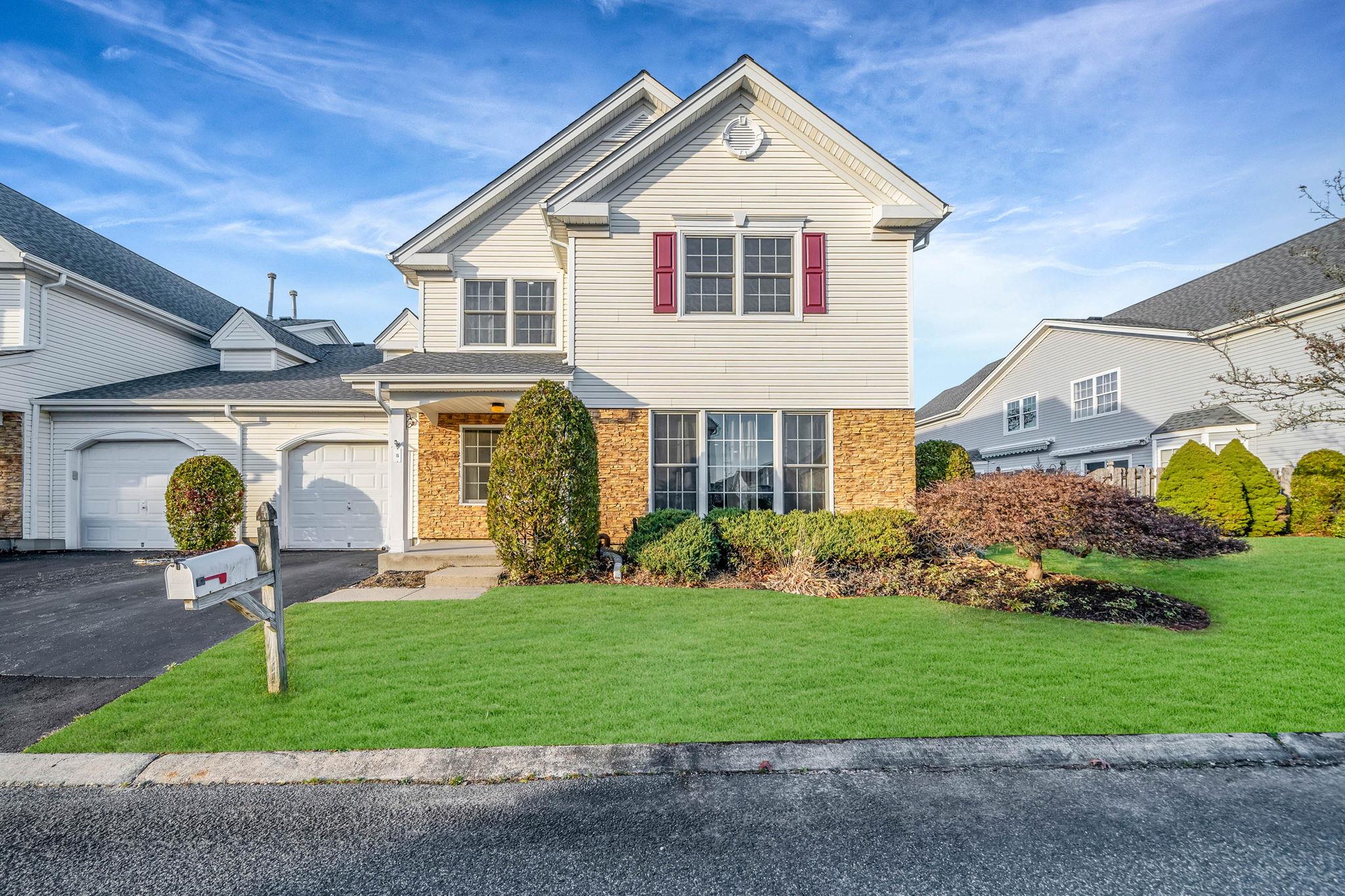 View of front property featuring a front yard and a garage