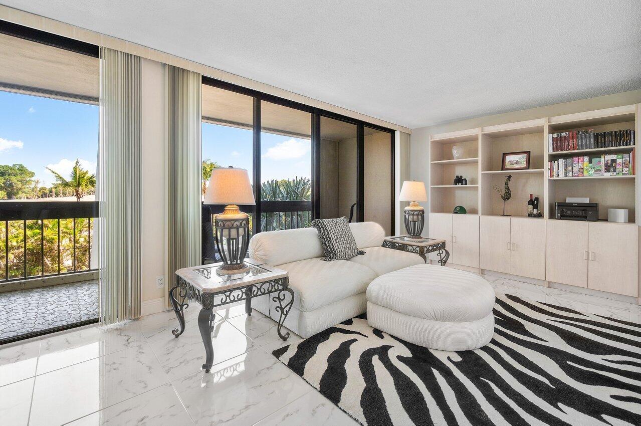 a living room with furniture and a floor to ceiling window