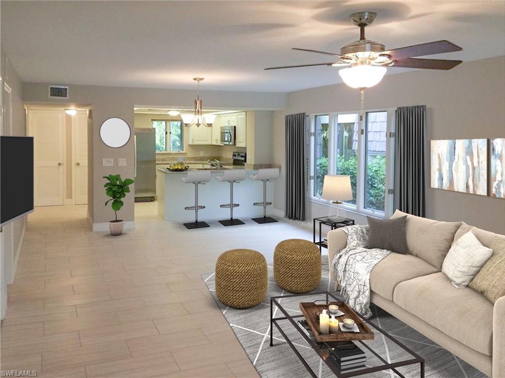 a living room with furniture and a chandelier