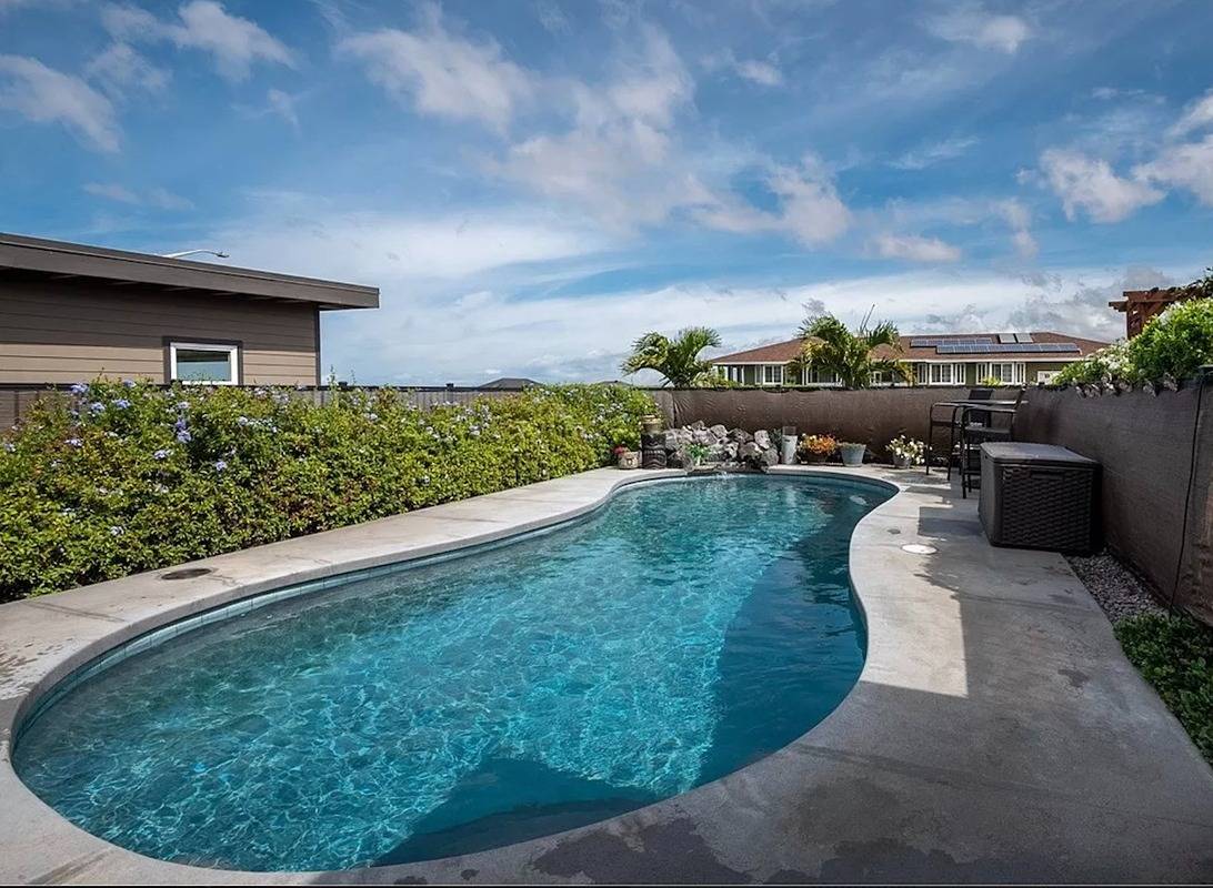 a view of a swimming pool with a yard