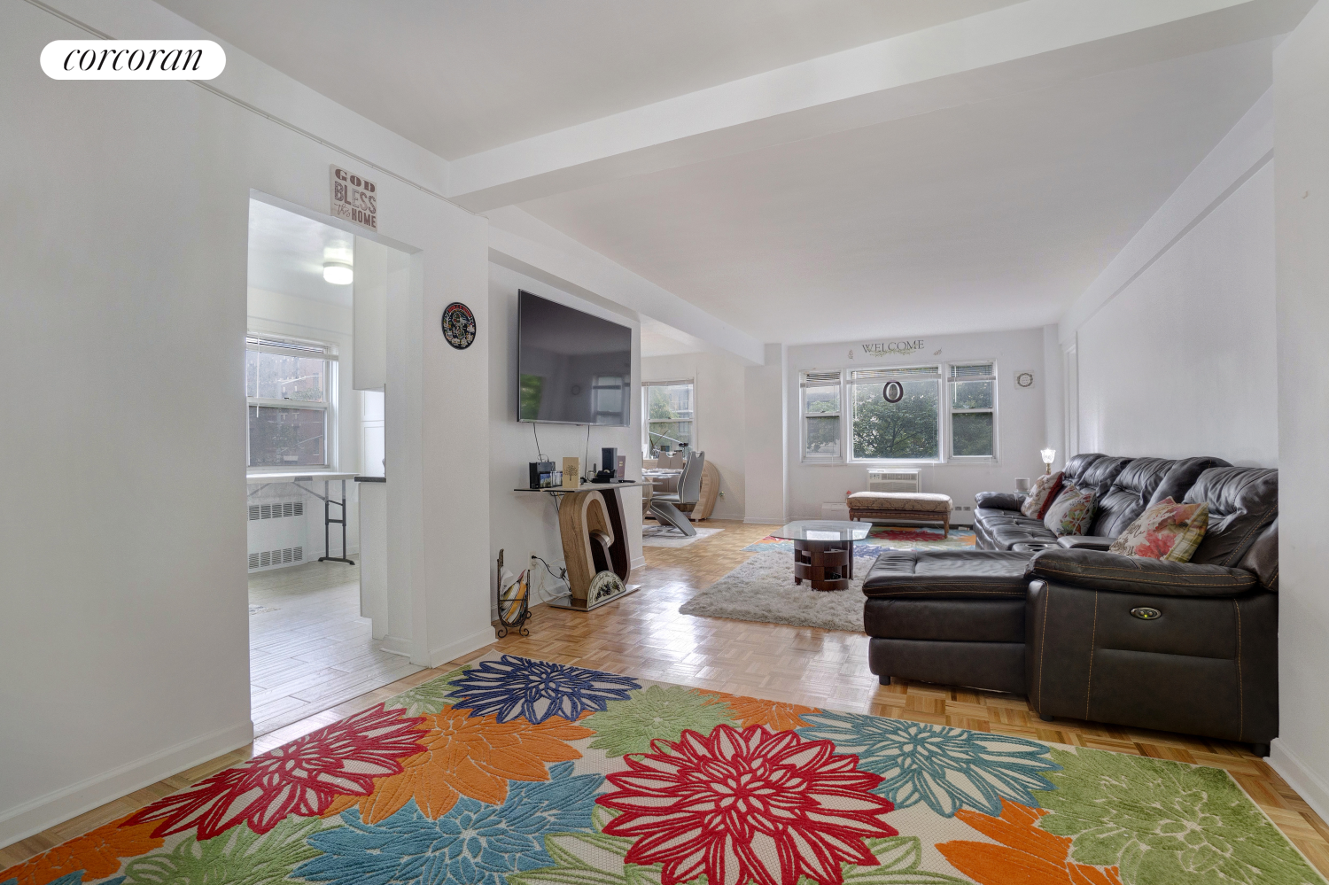 a living room with furniture and a wooden floor