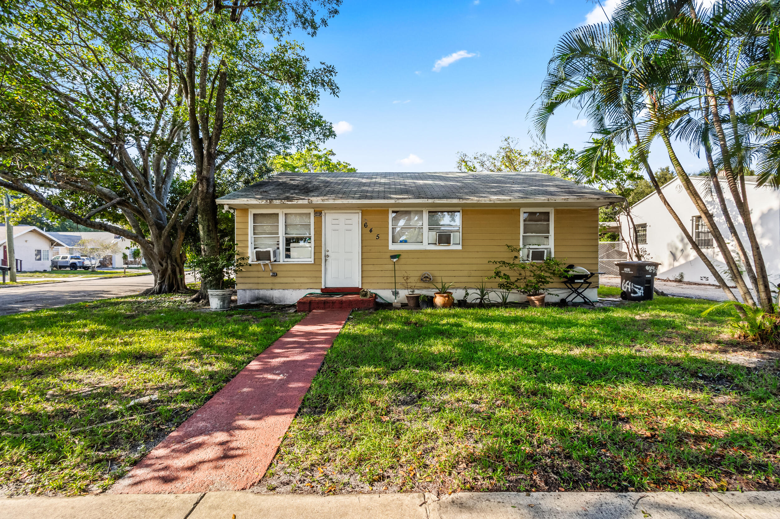 a front view of house with yard and green space