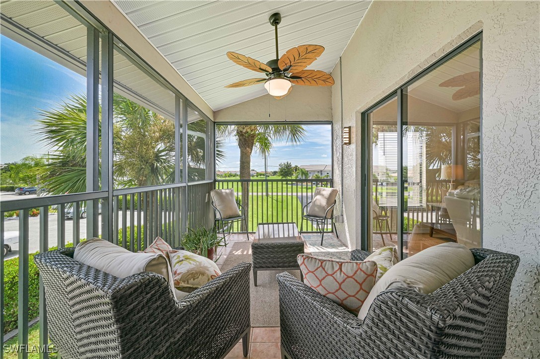 a balcony with furniture and large windows