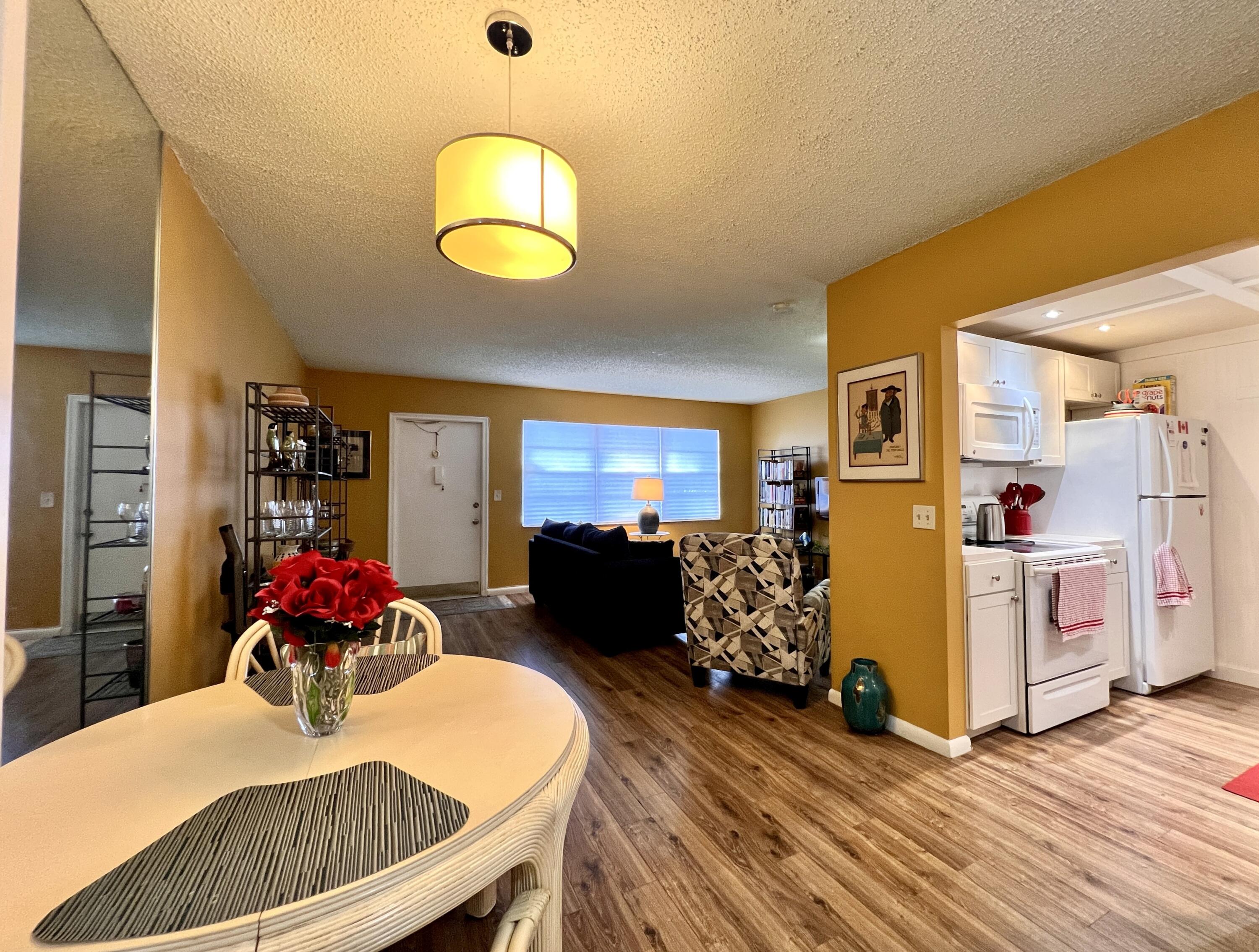 a dining room with furniture and wooden floor