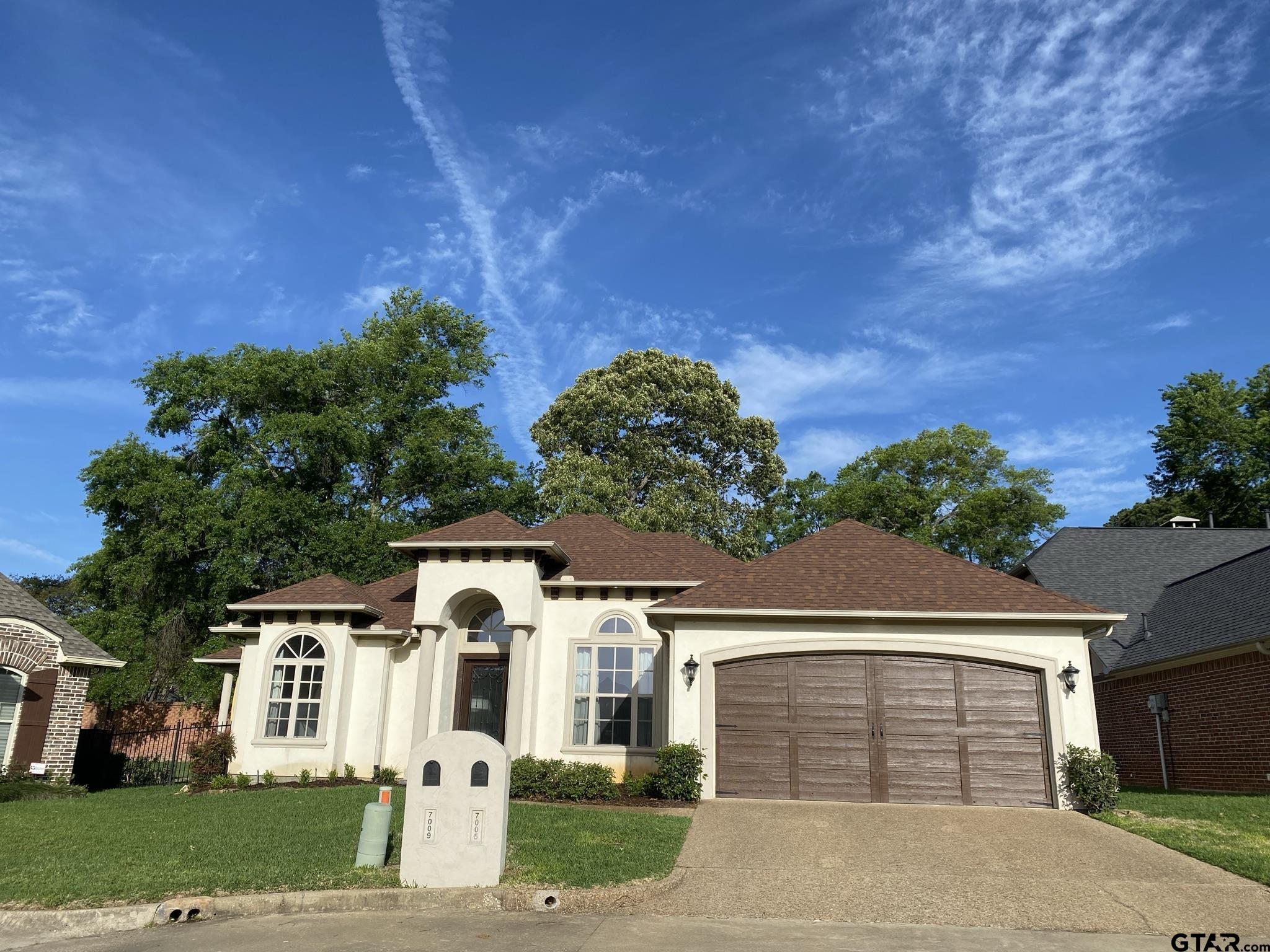 front view of a house with a garden