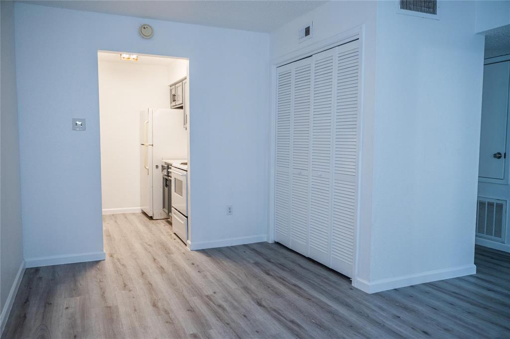 an empty room with wooden floor and a window