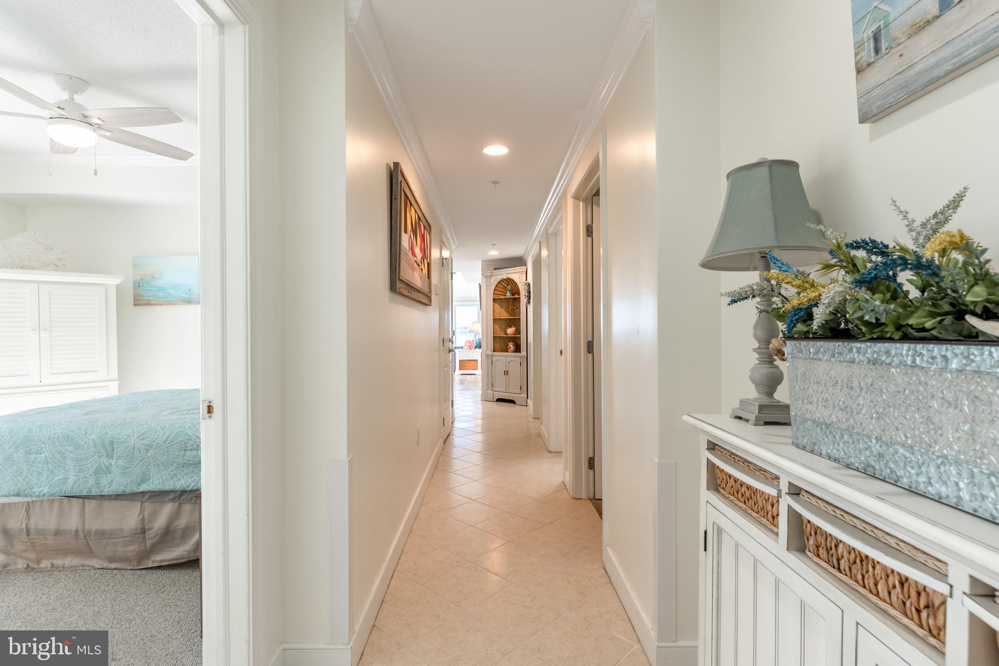 a view of a hallway to a livingroom and a couch