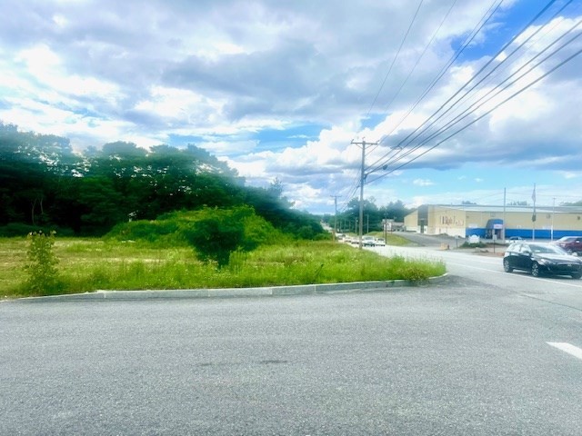 a view of a road with a big yard