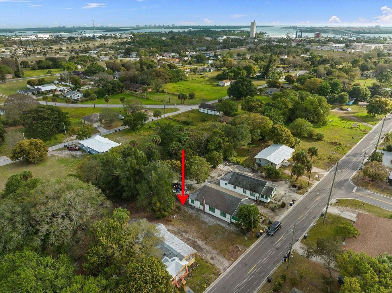 an aerial view of residential houses with outdoor space and trees