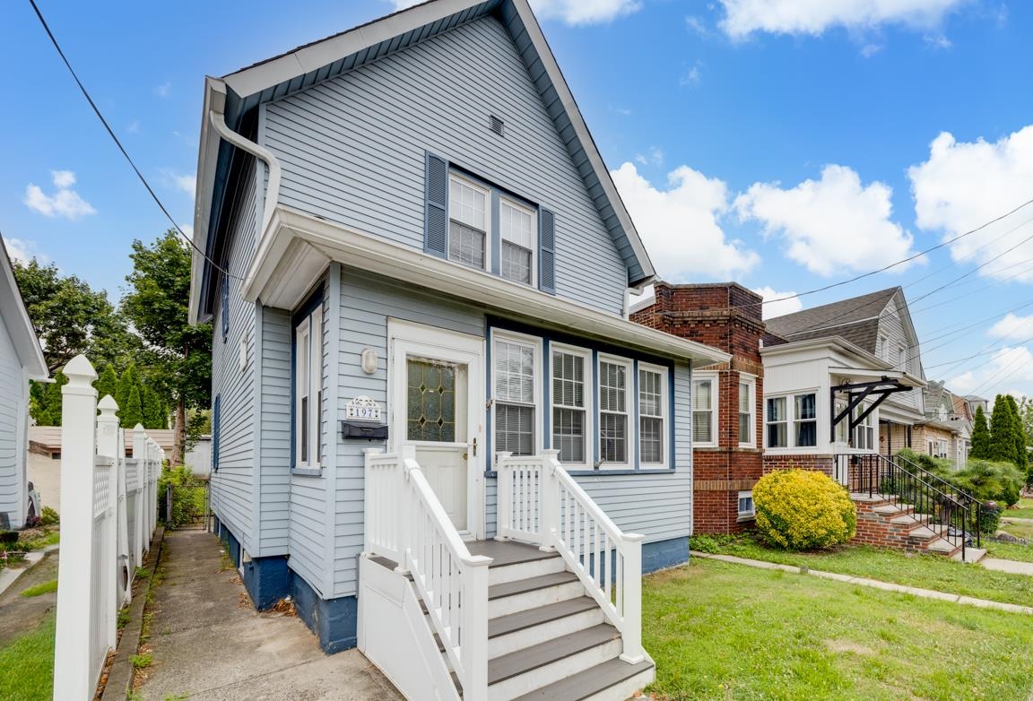 a front view of a house with a yard table and chairs