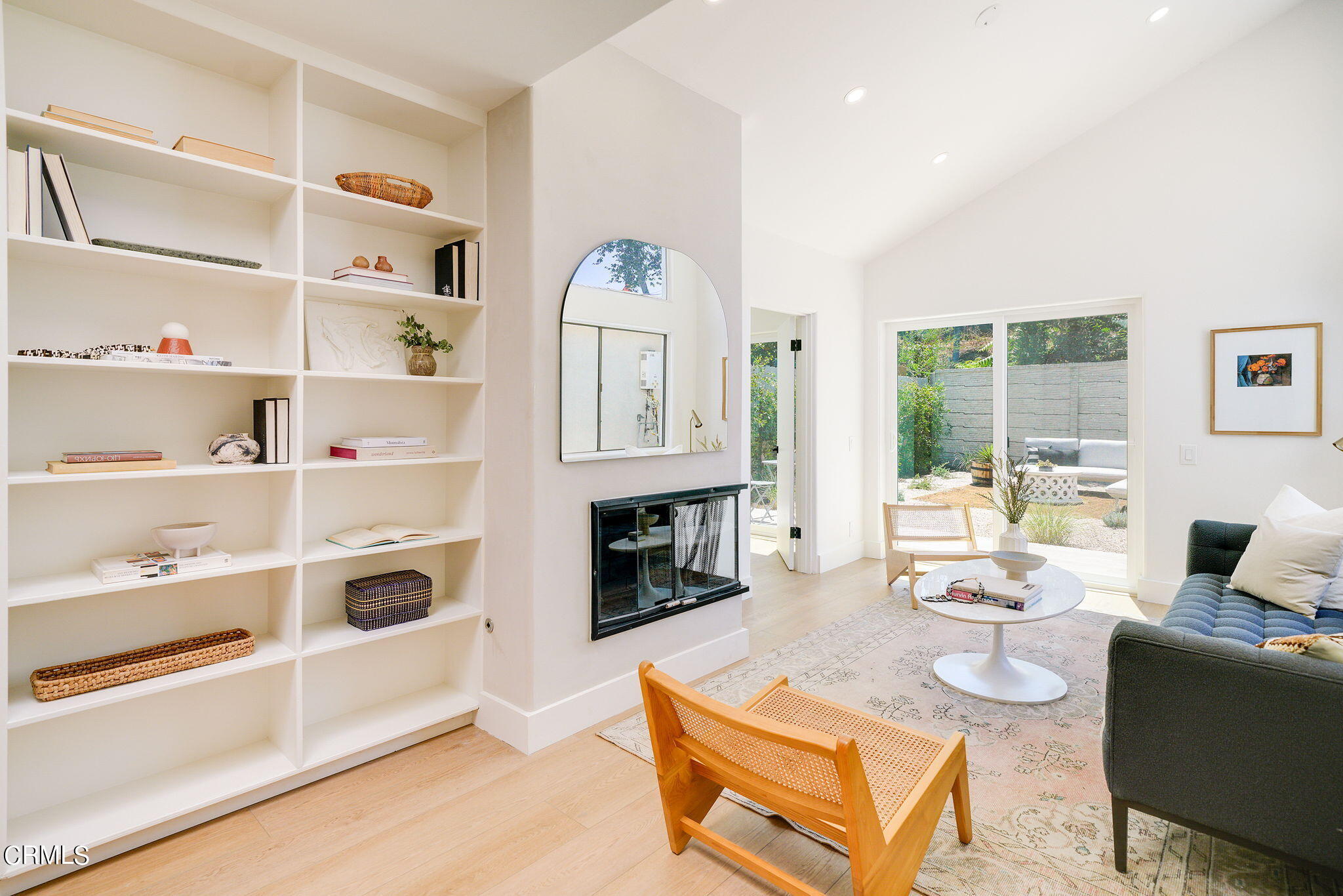 a living room with furniture a fireplace and a window