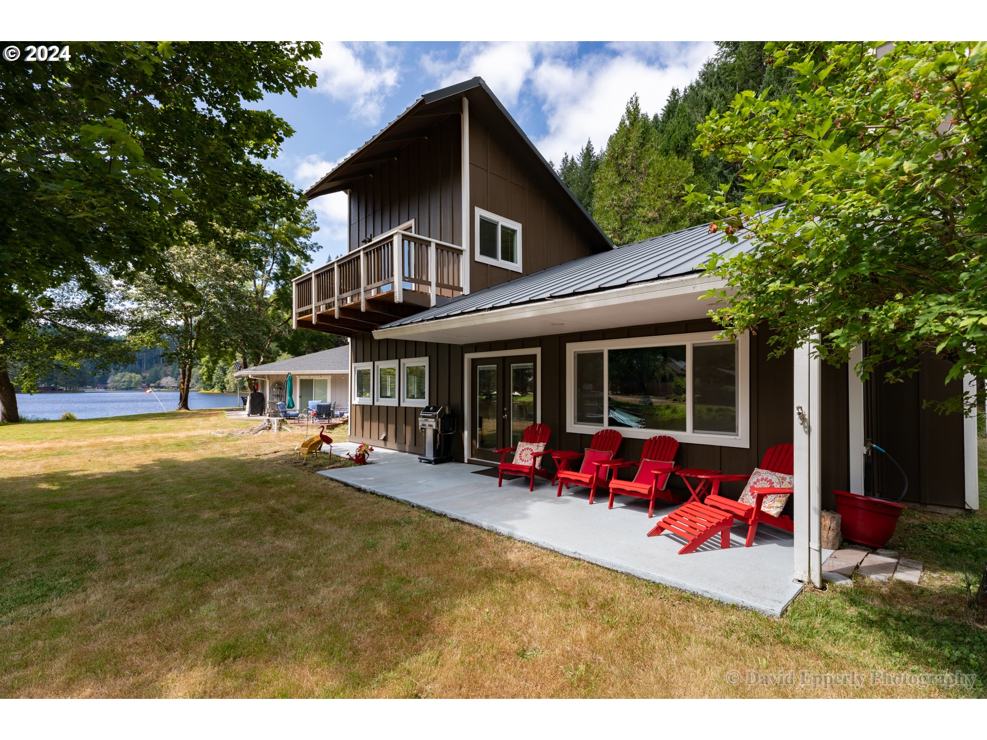 a view of a house with swimming pool and sitting area