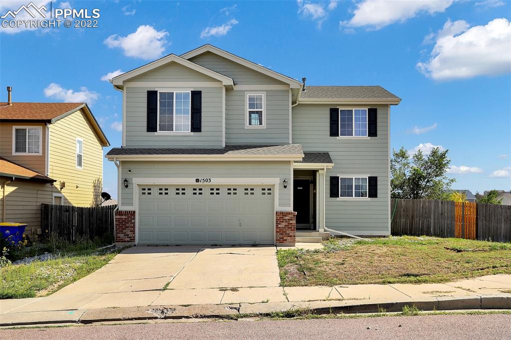 a front view of a house with a garage