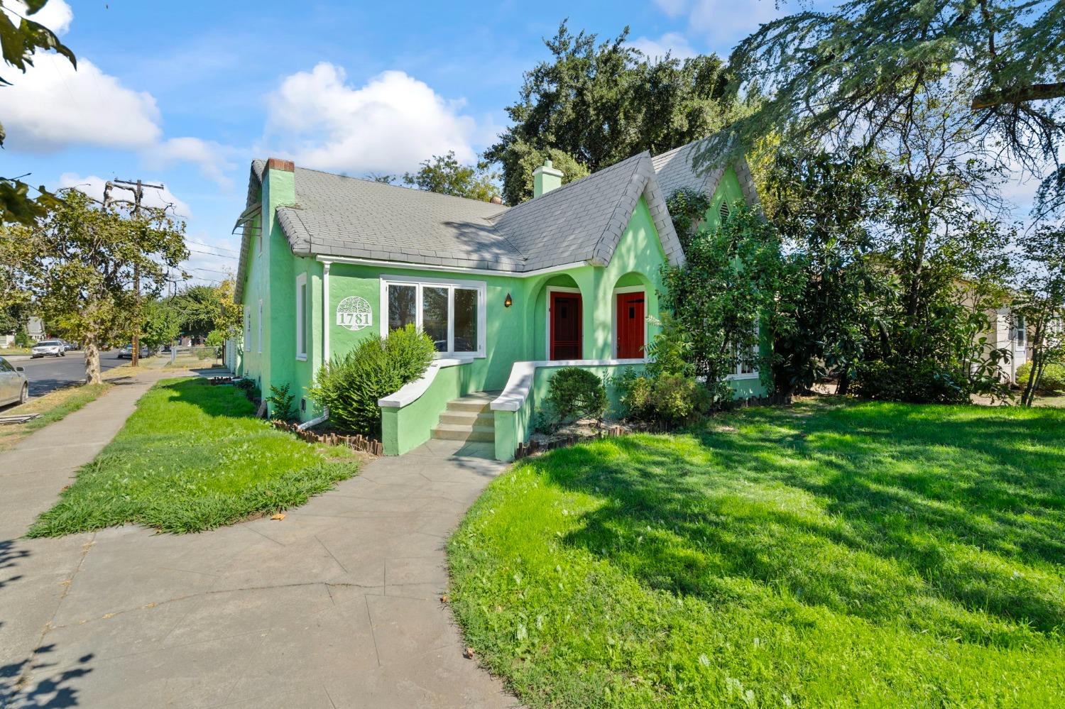 a view of a house with a backyard and a garden