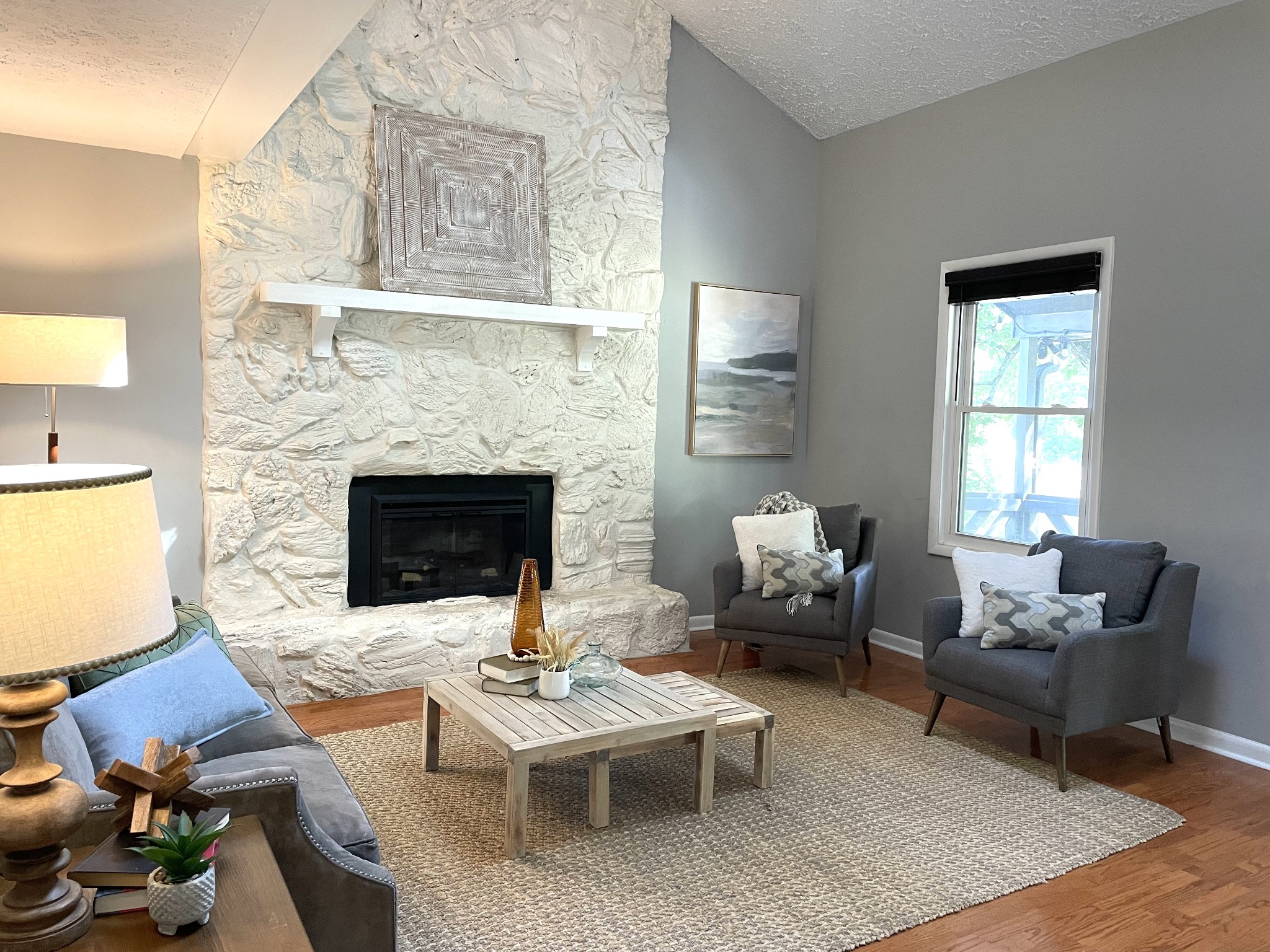 a living room with furniture fireplace and window