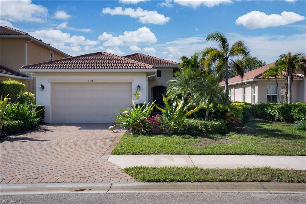 Mediterranean / spanish-style home with a garage