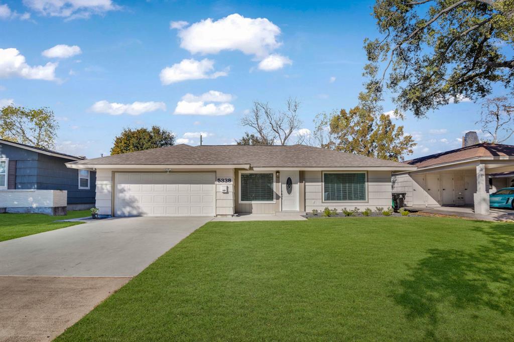 a house view with a sitting space and garden