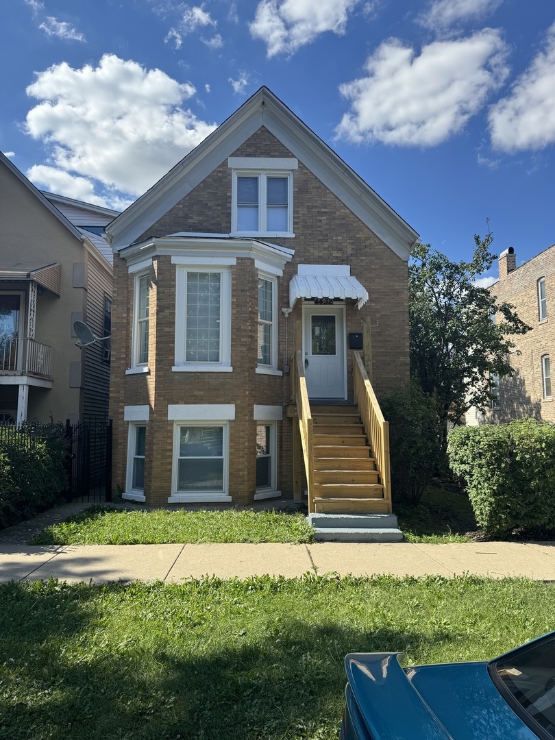 a front view of a house with a yard