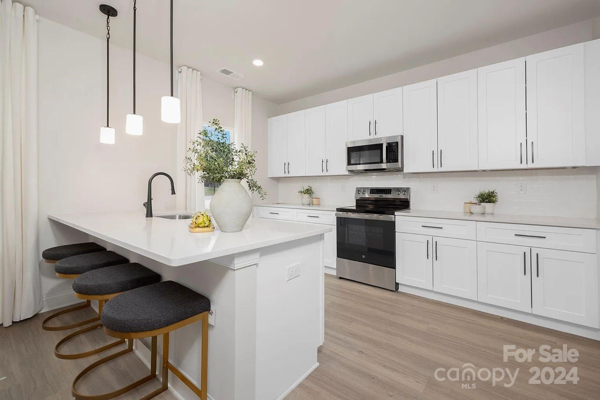 a kitchen with a sink cabinets and window