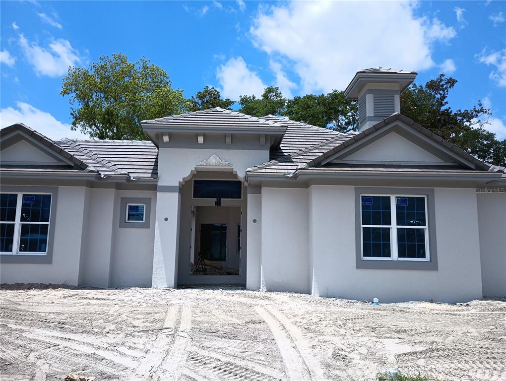 a view of a house with a yard and garage