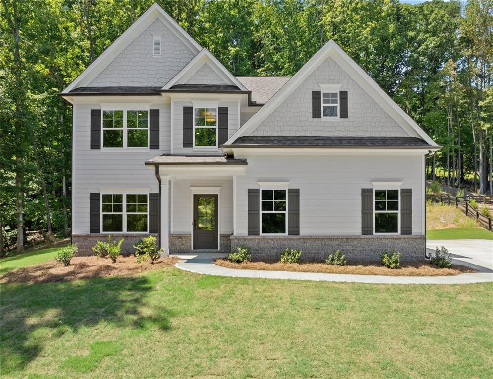 a front view of house with yard and green space