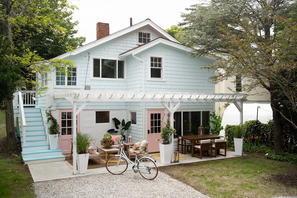 a view of a house with a patio and a yard