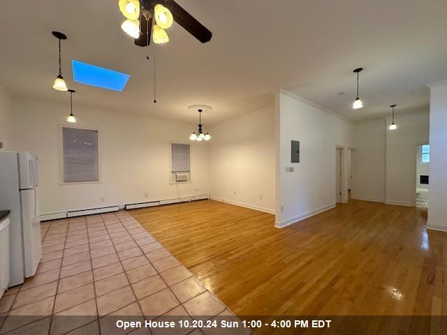 a view of an empty room and kitchen view