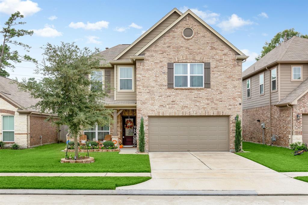 a front view of a house with a yard and garage