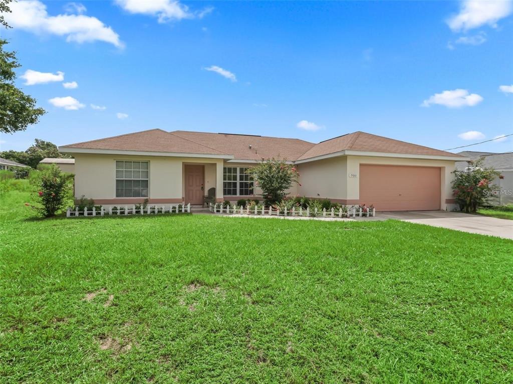 a front view of house with yard and green space